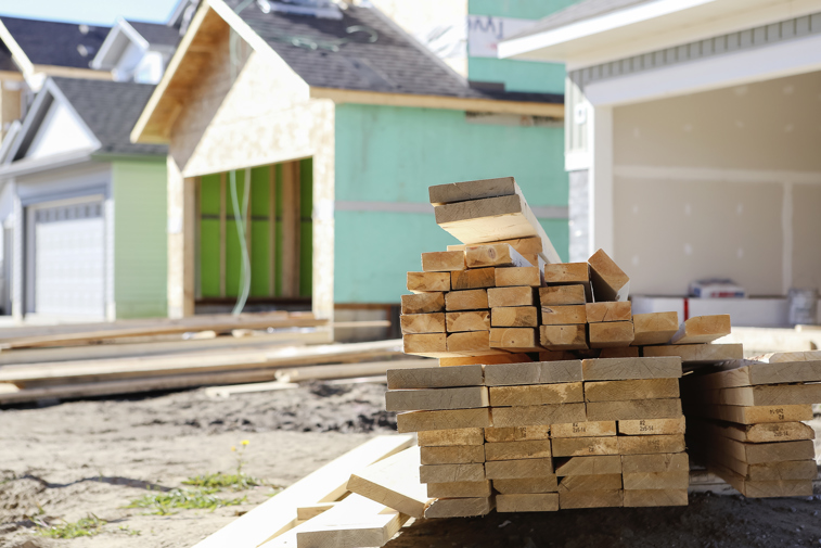 Boards waiting to become a home amid residential construction