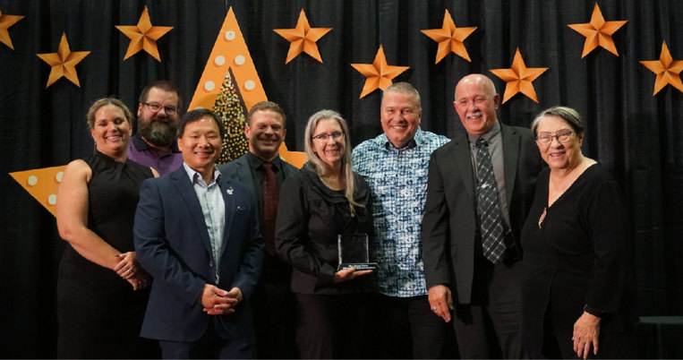 Members of Town Council present Mira Timber Frame's owners with the Award of Business Excellence